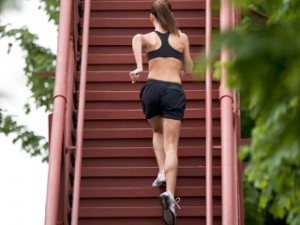 image of woman running up stairs